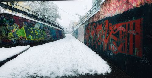 Graffiti on wall in city during winter