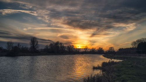 Scenic view of lake against sky during sunset