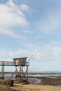 Lifeguard hut on beach against sky. fishery hut on beach against sky 