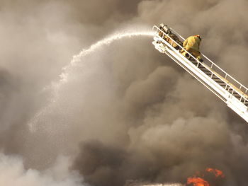 Low angle view of smoke against sky