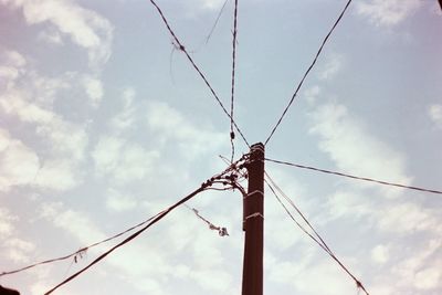 Low angle view of electricity pylon against sky