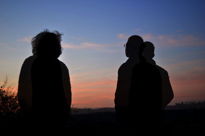 Silhouette of people at sunset