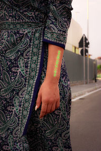 Midsection of woman standing on street