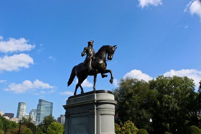 Low angle view of statue against blue sky