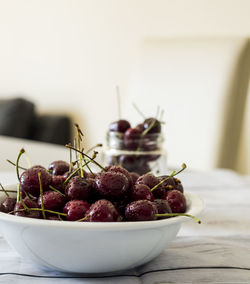 Close-up of red cherries in bowl on table