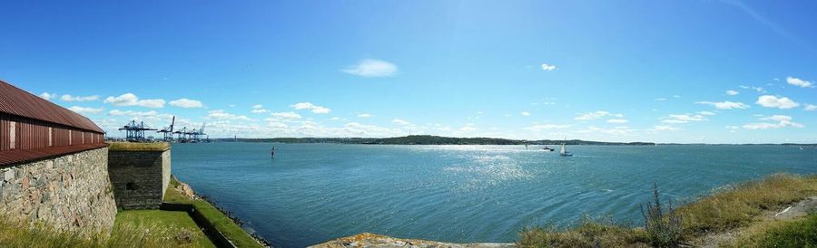 Calm sea against blue sky