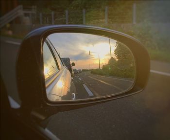 Reflection of clouds in side-view mirror