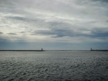 Scenic view of sea against cloudy sky