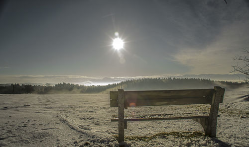 Scenic view of field against bright sun