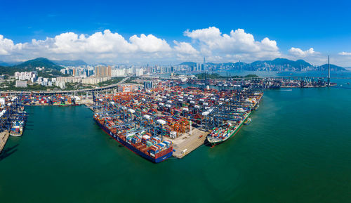 High angle view of cityscape by sea against sky