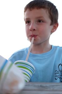 Portrait of young boy drinking