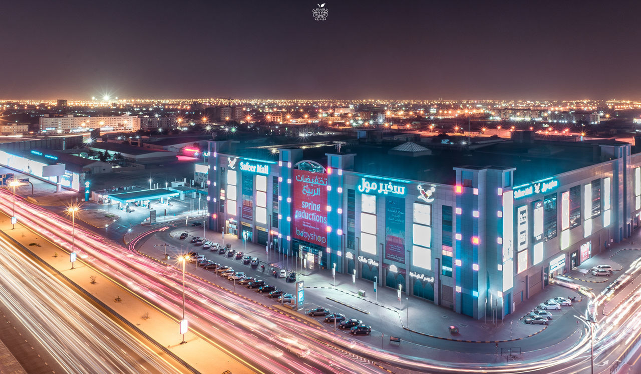 ILLUMINATED CITYSCAPE AGAINST SKY