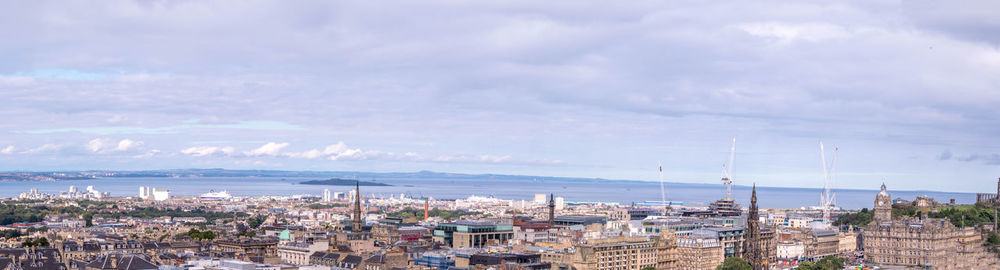 High angle view of townscape by sea against sky