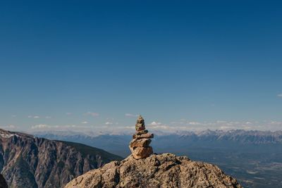 Rock on mountain against blue sky