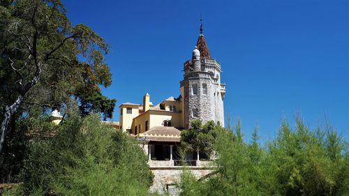 Low angle view of building against clear blue sky