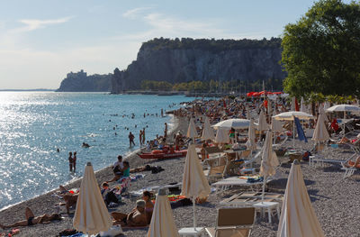 Group of people on beach against sky