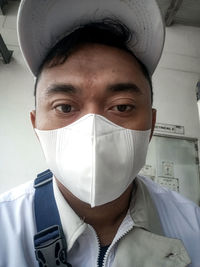 Portrait of young man covering face