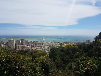 High angle view of trees and buildings against sky