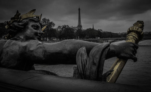 Close-up of statue against sky in city