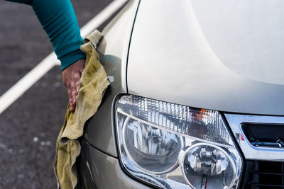 Low section of man washing car