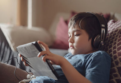 Boy using mobile phone at home