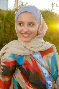 Portrait of smiling young woman wearing hijab