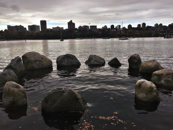 Scenic view of river by city against sky