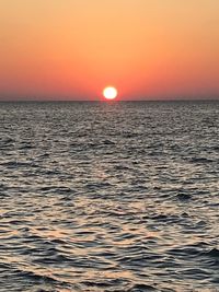 Scenic view of sea against orange sky