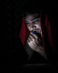 Portrait of young man in darkroom