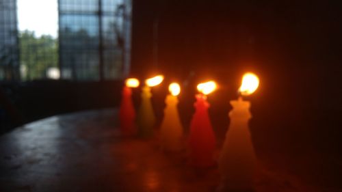 Close-up of hand burning candles