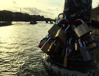 Close-up of padlocks on river in city
