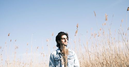 Portrait of a guy  standing against clear sky