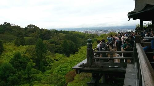 Panoramic view of people on mountain against sky