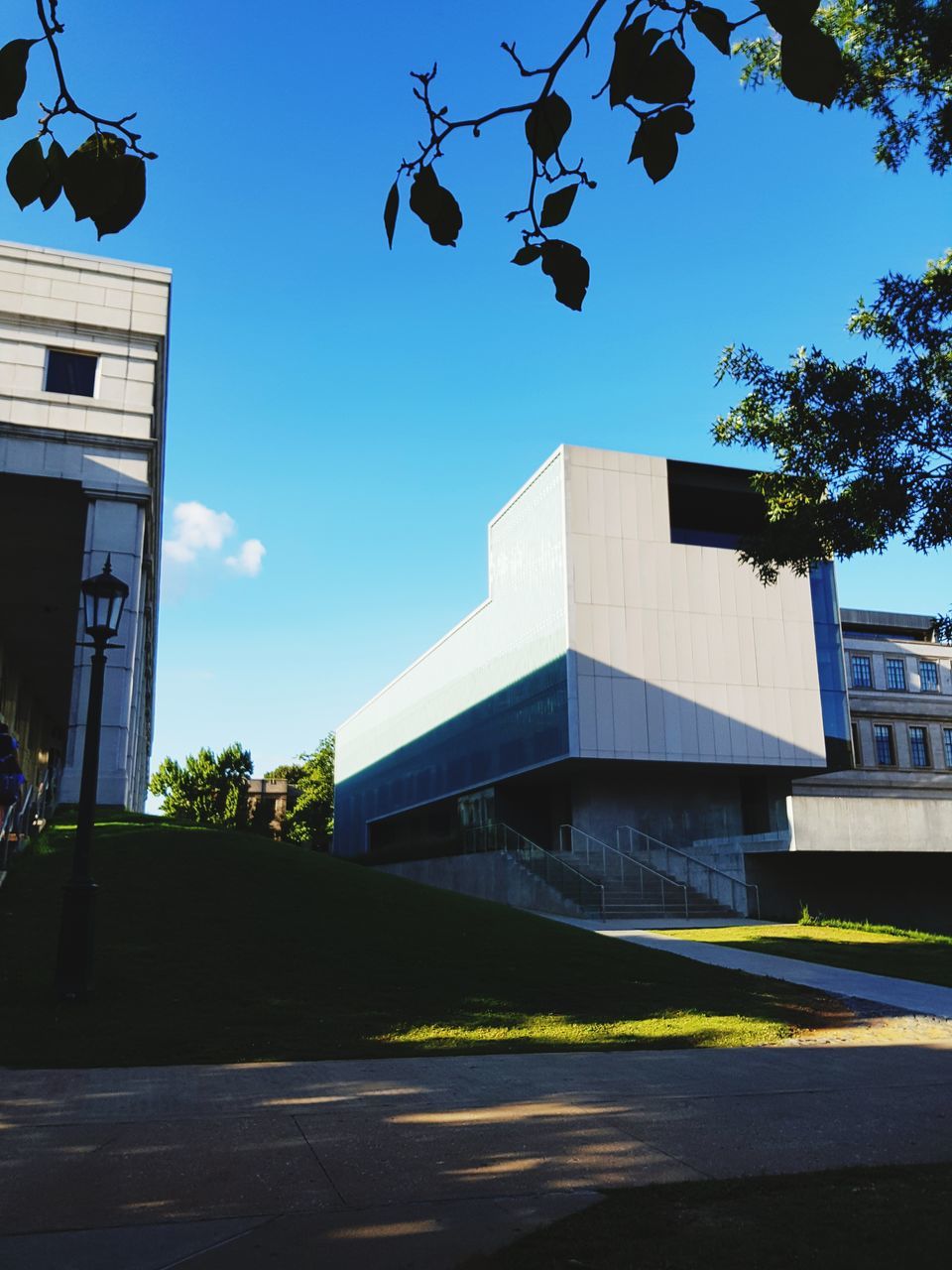 LOW ANGLE VIEW OF BUILDING AND STREET AGAINST SKY