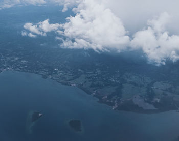 Aerial view of sea and mountains against sky