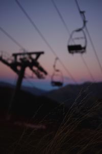 Close-up of telephone pole against sky at sunset