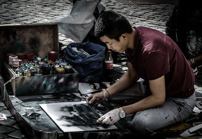 Street artist working at workshop