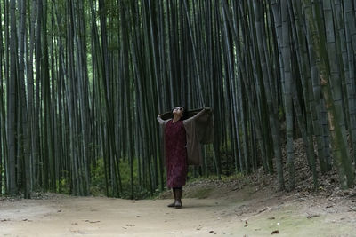 Woman walking in forest
