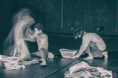 Men doing laundry while performing on stage