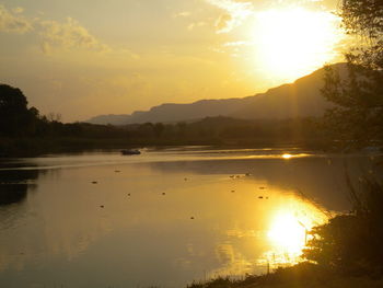 Scenic view of lake against sky during sunset