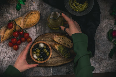 Low section of person standing amidst food on table