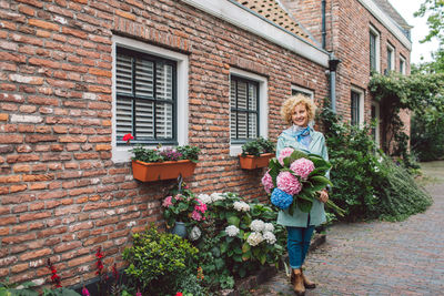 High angle view of woman standing against brick wall