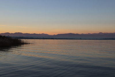 Scenic view of lake against sky during sunset