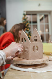 Women's hands knead clay, drawing elements of the product. production of ceramic products. 