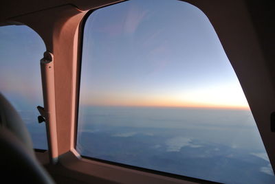 Close-up of airplane interior against sky during sunset