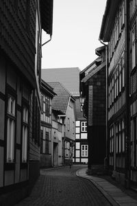 Empty alley amidst buildings in city