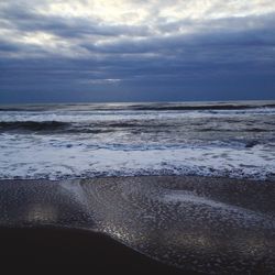 Scenic view of beach against sky during sunset