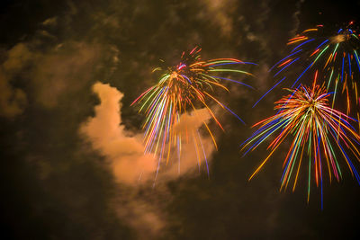 Low angle view of firework display at night