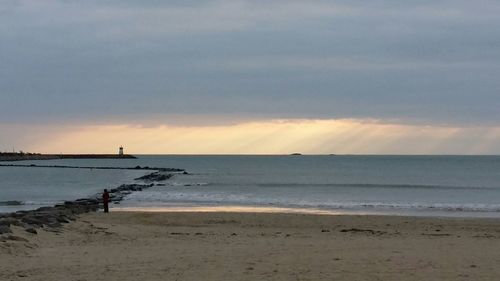 Scenic view of sea against cloudy sky