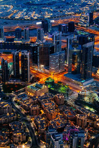 High angle view of city street and buildings at dusk